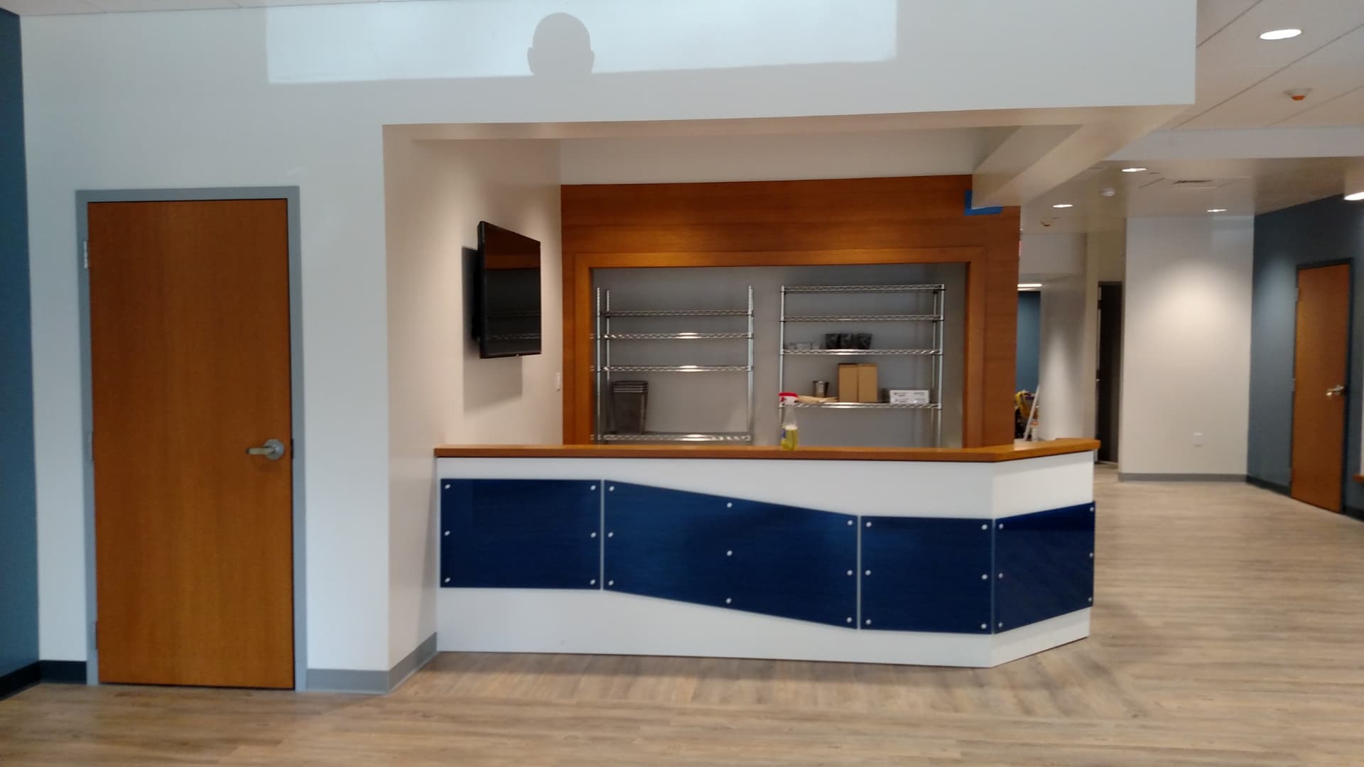 New player services desk with wood trim and blue panel front