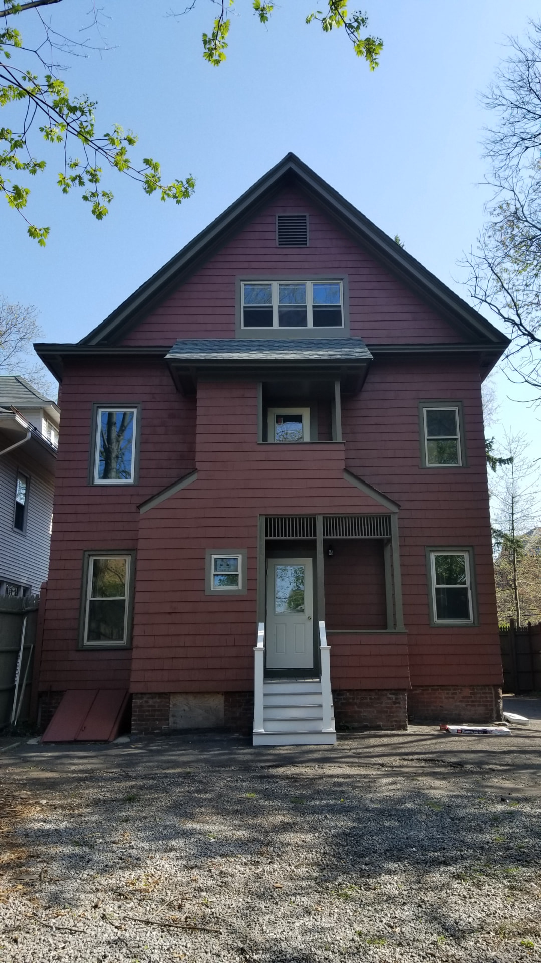 Rebuilt home exterior with new siding, windows, roof and entry stairs